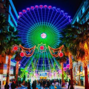 a large ferris wheel in a city at night at Casa Punta Balea, en el centro in Cangas de Morrazo