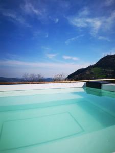 a swimming pool with a view of a mountain at Ca' Baetti l'Antica Corte in Roncola