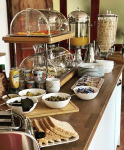 a kitchen counter with a buffet of food on it at Uhldinger-Hof in Uhldingen-Mühlhofen