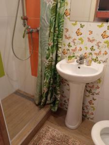 a bathroom with a sink and a shower curtain at Jurmala's Centre Apartments in Jūrmala