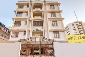 a large white building with a gate in front of it at OYO Flagship 78696 Hotel Kamini in Patna