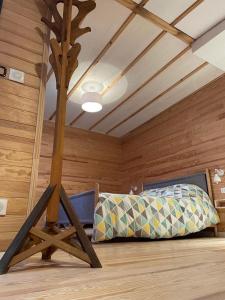 Habitación con cama en una cabaña de madera en L'écolodge de Laeti, en Lunéville