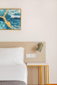 a bedroom with a bed and a lamp on a table at Casa Lolita in Barcelona