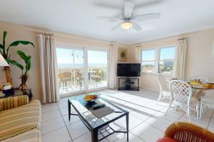 a living room with a couch and a table at 508 - South Beach Condos in St. Pete Beach