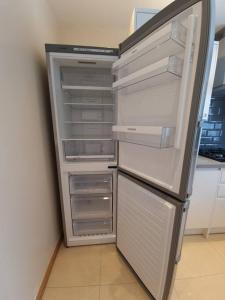 a refrigerator with its door open in a kitchen at London Luxury 2 Bedroom Flat Sleeps 8 free parking in East Barnet