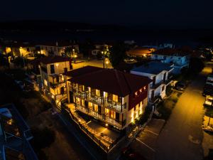 a lit up city at night with a building at Helianthus Guesthouse in Ammouliani