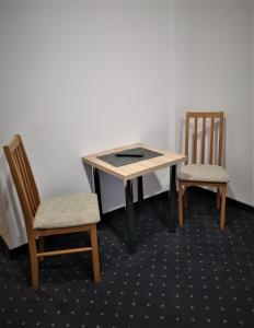 a table and two chairs in a room at HOMER Bydgoszcz in Bydgoszcz