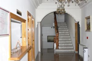 a hallway with a staircase with a chandelier at Hotel Monterrey in Pradorrey