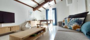 a living room with a couch and a flat screen tv at Le Duplex 4 Pers - 10 min des plages in Sainte-Croix-de-Verdon