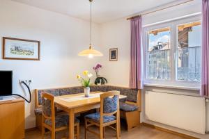 a dining room with a table and chairs and a window at Valtlhof - Apt 1 in Cornaiano