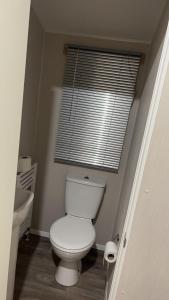 a bathroom with a white toilet and a window at Heaven Haven in Tattershall +6 photos