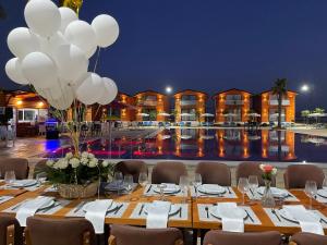 a long table with white balloons and a pool at Kingfish restaurant & boutique hotel in Patog +41 photos