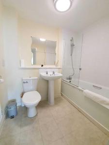 a bathroom with a toilet and a sink and a shower at Dazzon Apartments - HUB - Central MK in Milton Keynes