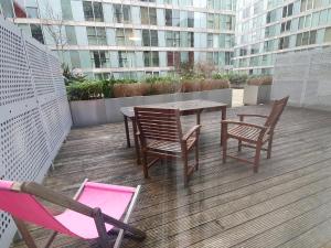 a patio with a table and chairs on a balcony at Dazzon Apartments - HUB - Central MK in Milton Keynes