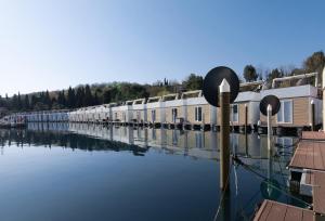 a river with a row of houses on the water at Eldamar Floating House Portorož in Portorož