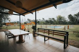 a pavilion with a table and bench and a playground at Casa Brunia Lago Los Molinos in Villa General Belgrano +19 photos