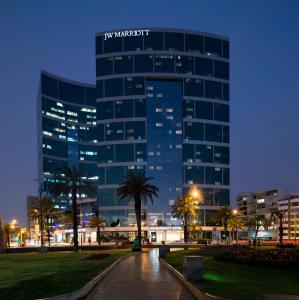 un palazzo alto con un cartello di notte di JW Marriott Hotel Lima a Lima