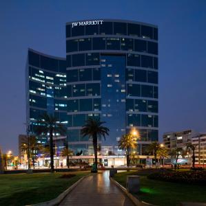 a tall building with a sign on it at night at JW Marriott Hotel Lima in Lima