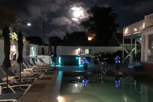 a pool at night with the moon in the background at Captivating Cottage in Provincetown