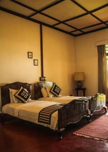 מיטה או מיטות בחדר ב-Ancoombra Tea Estate Bungalow