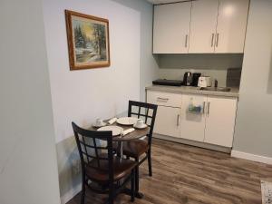 a kitchen with a table and chairs in a room at Winnipeg Peace Home in Winnipeg