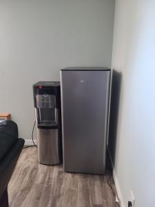 a refrigerator and a trash can in a room at Winnipeg Peace Home in Winnipeg