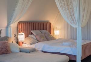a bedroom with a large bed with a canopy at Magiczne gniazdko na samym Rynku in Wrocław