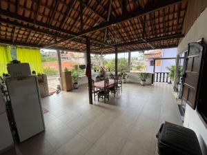 a large room with a table and chairs in a house at Guest House da Cris in Itabira