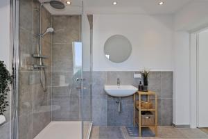 a bathroom with a glass shower and a sink at 'Traveller lodge' großzügiges Apartment - 3 BR, 10min to Hbf, full kitchen, homeoffice, Netflix, Wifi in Düsseldorf +16 photos