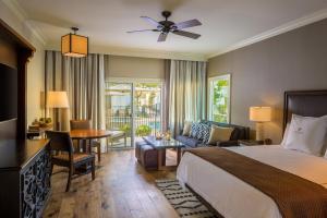 a hotel room with a bed and a living room at La Cantera Resort & Spa in San Antonio