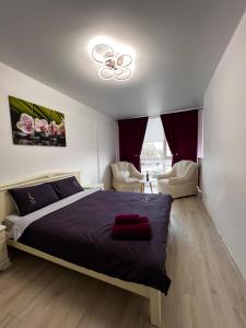 a bedroom with a bed and a ceiling fan at New Apartment in Ivano-Frankivsʼk