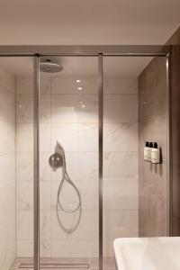 a shower with a shower head in a bathroom at Finest Apartments in Haarlem