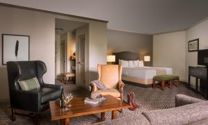 a hotel suite with a bed and a living room at La Cantera Resort & Spa in San Antonio