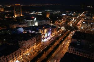 a view of a city at night with lights at El Mouradi Hotel Africa Tunis in Tunis