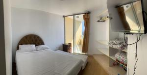 una camera con un letto e una televisione di Apartment 03 dormitorios San Miguel a Lima