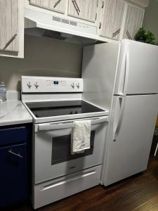 a kitchen with a white stove and a refrigerator at Eagle Stay in Eagle Pass