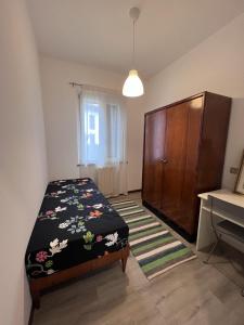 a bedroom with a bed and a dresser in it at Buonarroti 37 in Gorgonzola