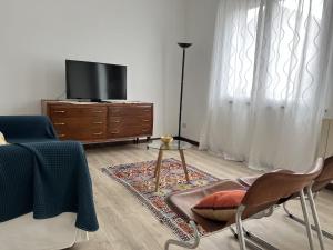 a living room with a tv and a table and chairs at Buonarroti 37 in Gorgonzola