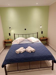 a bedroom with a bed with two towels on it at Newly renovated apartment next to the port in Corfu Town