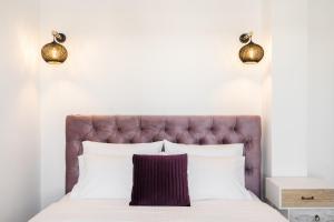 A bed or beds in a room at SN Santorini Apartments