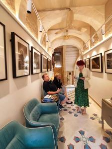 a woman standing next to a group of people in a room at The Heritage Boutique Accommodation in Rabat