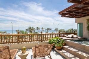 a patio with two chairs and a swimming pool at Gran Mareiro Hotel in Fortaleza