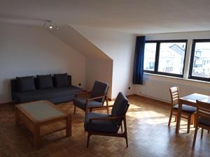 a living room with a couch and chairs and a table at ZumLeroy in Völklingen