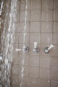 a tiled bathroom with two urinals and a shower at Monte da Bela Raposa in Pavia +29 photos