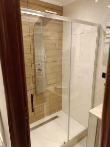 a shower with a glass door in a bathroom at Newly renovated apartment next to the port in Corfu Town