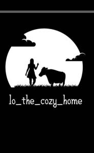 a woman and a cow in a field with the moon at Io the cosy home Plomari in Plomari