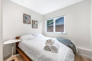 a bedroom with a bed with towels on it at Luxury Delta 2BD Suit on ground floor in Delta