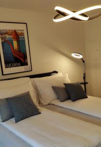 a bedroom with a white bed with a ceiling fan at Seven Swiss Wonders, City Center in Zürich