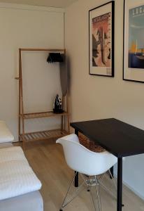 a bedroom with a black desk and a white chair at Seven Swiss Wonders, City Center in Zürich