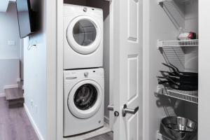 a washer and dryer in a white laundry room at Condo in Southeast Calgary in Calgary